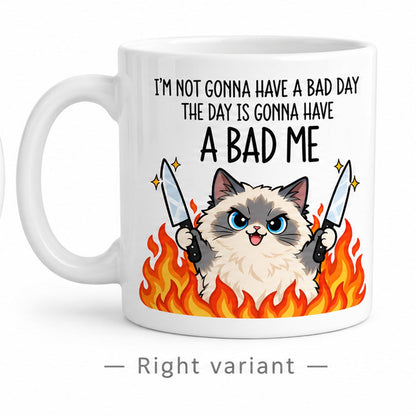 Rendering of white ceramic mug with cartoon pumped ragdoll cat saying "I'm not gonna have a bad day" on white background. Print on right side view.