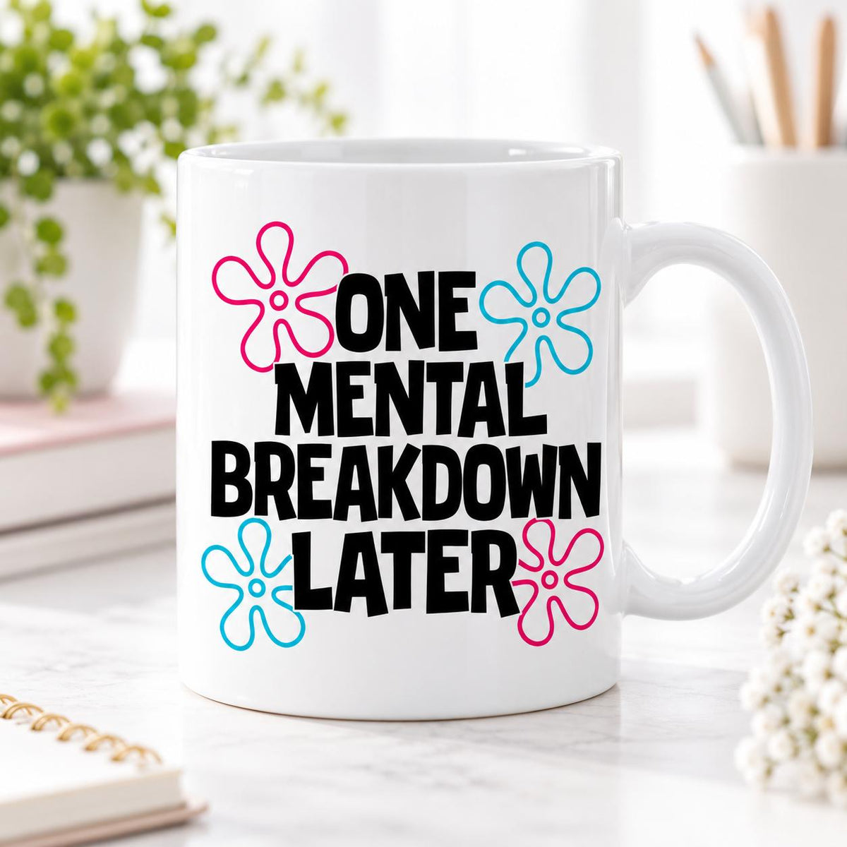 Rendering of white ceramic mug with cartoon text "One mental breakdown later" on wooden table. 
