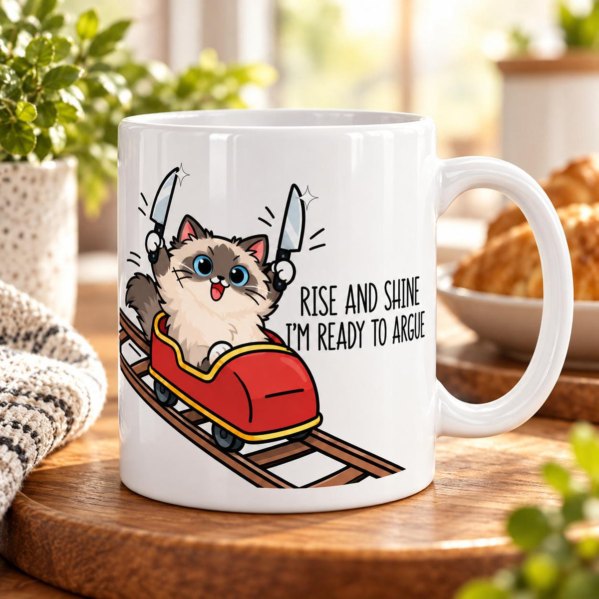 Rendering of white ceramic mug with cartoon happy ragdoll cat saying "I can rise & shine. I'm ready to argue" on wooden table.